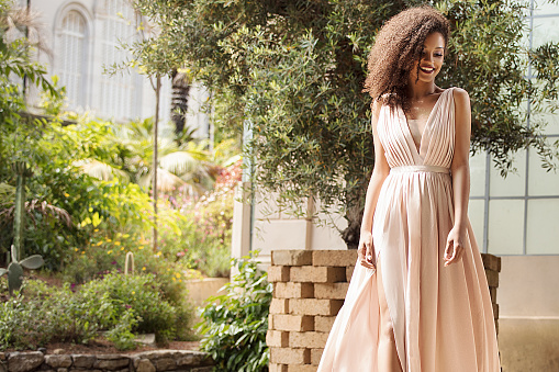 Elegant beautiful african american woman posing in maxi dress outdoor.