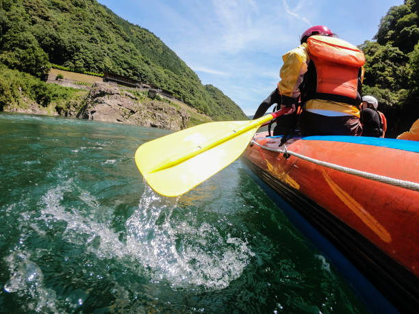 istock Low angle view of a white water river rafting excursion 990643342