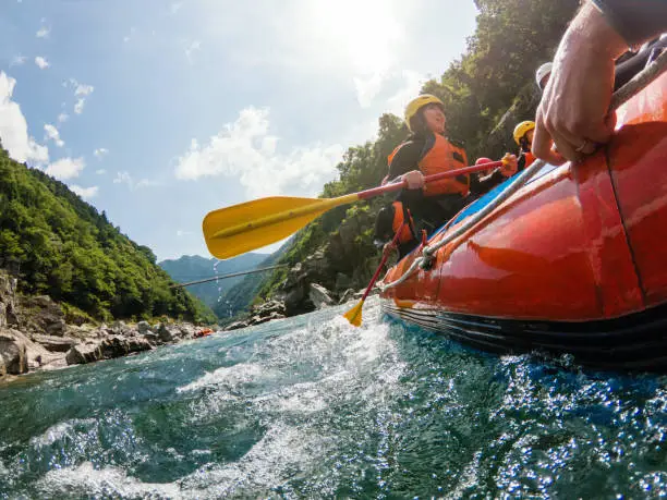 Photo of Low angle view of a white water river rafting excursion