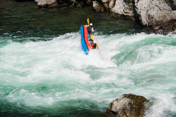 istock Small group of men and women about to crash while white water river rafting 990645982