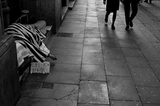 Barcelona, Spain, February 11, 2018\nHomeless in Barcelona with a sign of \