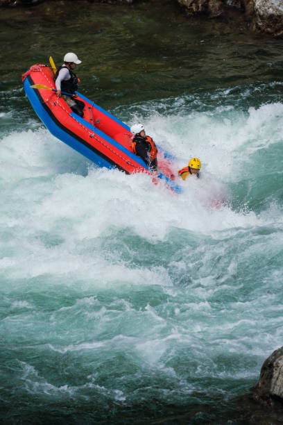 istock Small group of men and women about to crash while white water river rafting 990646228