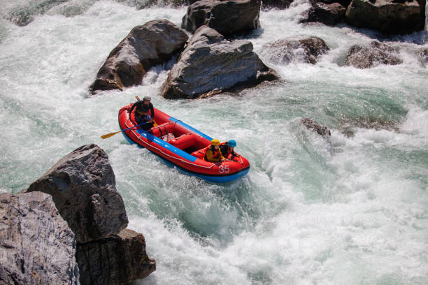 istock Married couple on a guided white water river rafting tour 990646540