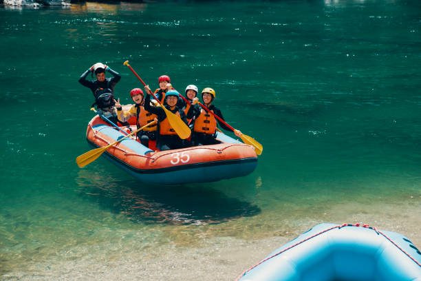 istock Group of men and women in a raft on a river 990648914