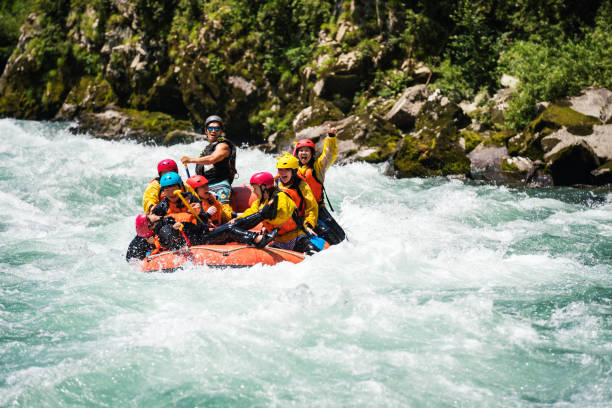 istock Group of men and women white water river rafting 990649106
