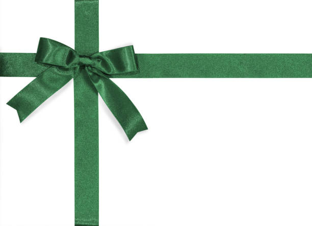 Green bow satin ribbon isolated on white background with clipping path for gift box wrap and holiday card design decoration element