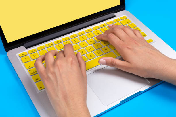 istock Yellow Keyboard Concept with woman hand 990660188