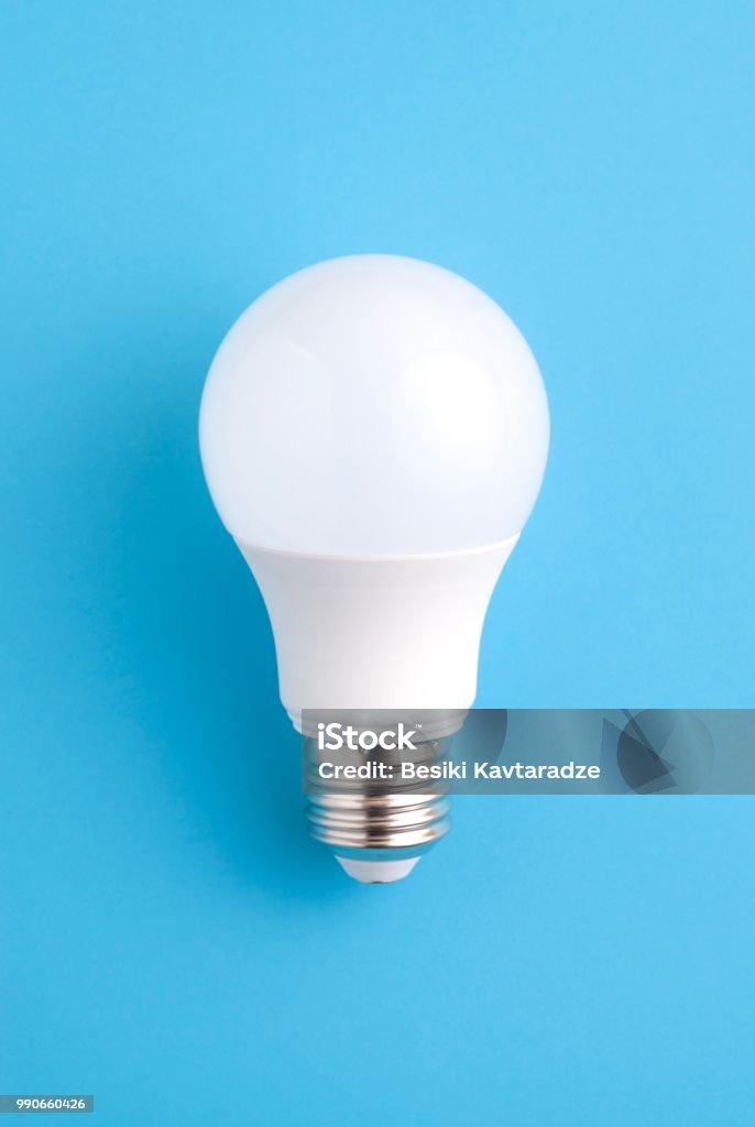 White light bulb White light bulb on blue Light Bulb Stock Photo