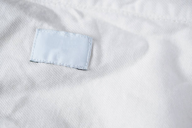 istock White blank laundry care clothes label on cotton shirt 990660470