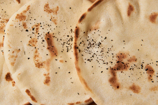 istock Pita bread background on wooden board table 990666786