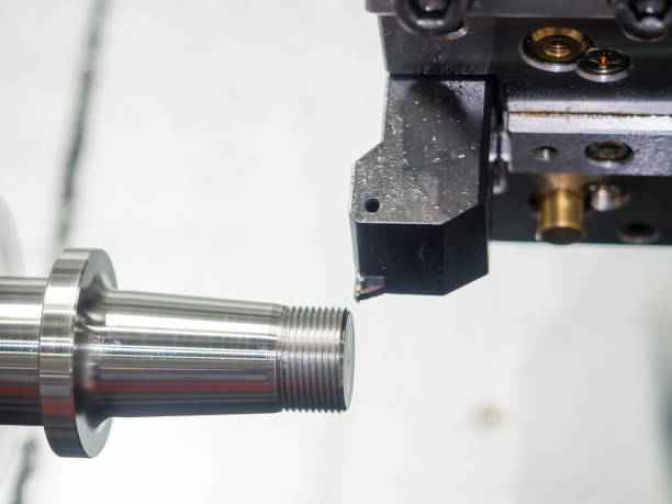 istock Operator machining automotive part by cnc turning machine, 990668052