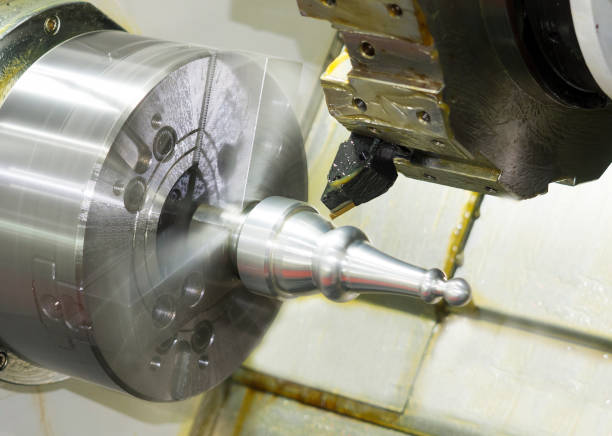 istock Operator machining automotive part by cnc turning machine, 990668064