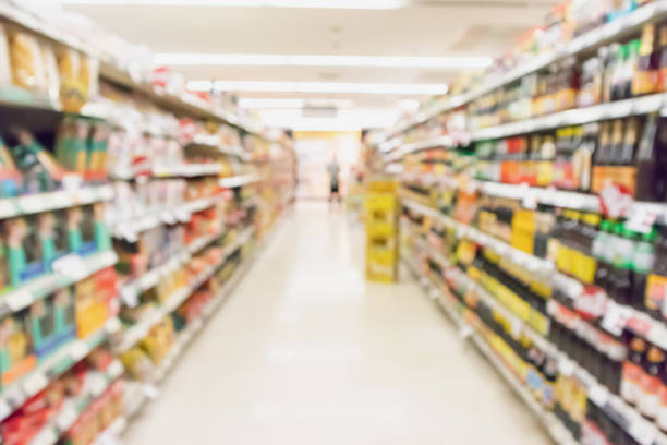 istock supermarket aisle with product on shelves blurred background 990678018
