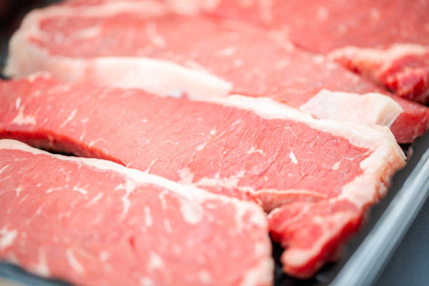 istock Raw New York strip steak ready for outdoor grilling. 990708634