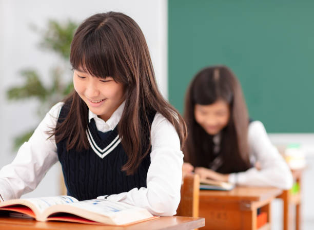 istock teenagers girl student studying in classroom 990711500