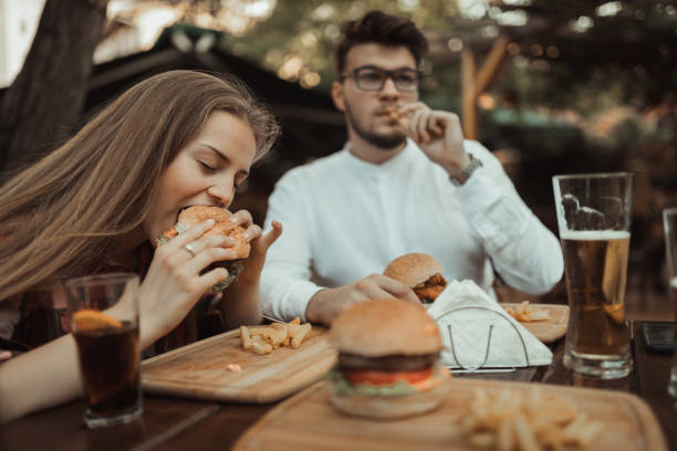 istock Young people eating and having fun in the pub 990714438