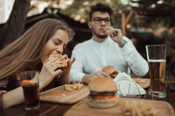 istock Two people eating and having fun in the pub 990714956