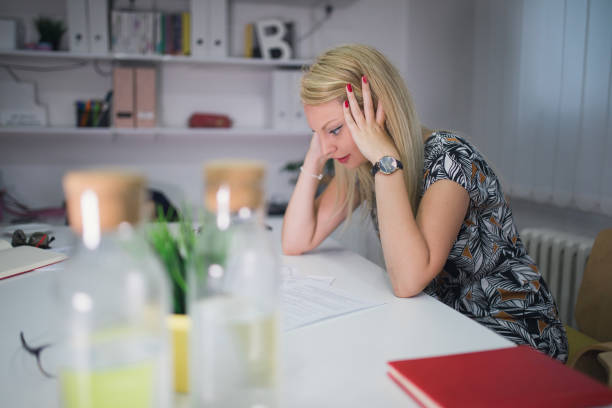istock Exhausted woman working late in the office 990718172
