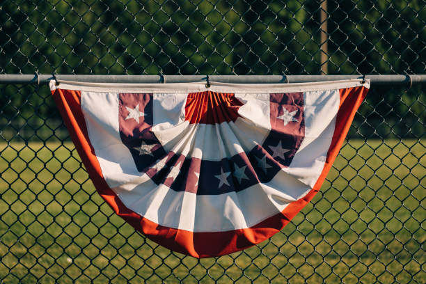 Red white and blue flag centered on a metal fence