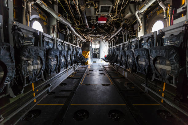 istock Interior of plane fuselage with seats and ground attachment points 990754868
