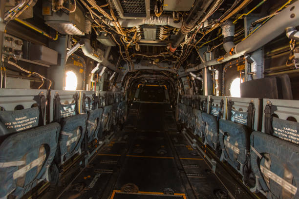istock Interior of plane fuselage with seats and ground attachment points 990754932