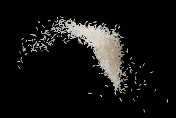 istock Stop motion white rice splash or explode flying in the air  isolated on black background food object design 990755040