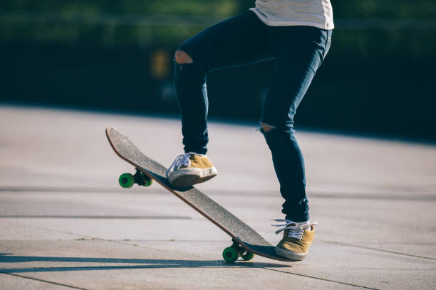 istock Skateboarder skateboarding at city 990771080