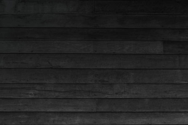 istock Wood plank black texture background. Wooden wall all antique cracking weathered peeling wallpaper. Vintage oak woodwork furniture table painted hardwoods. 990778250