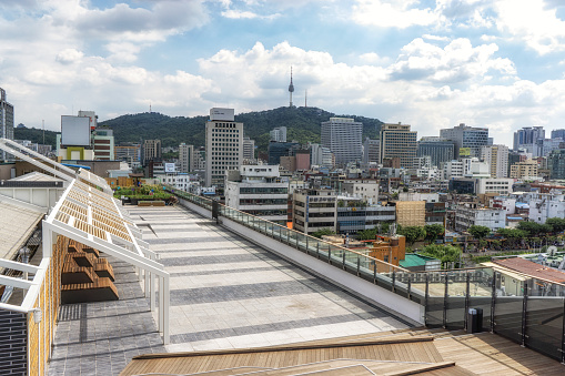 Sewoon plaza rooftop garden with benches and the view of Seoul city with seoul Namsan tower in the distant