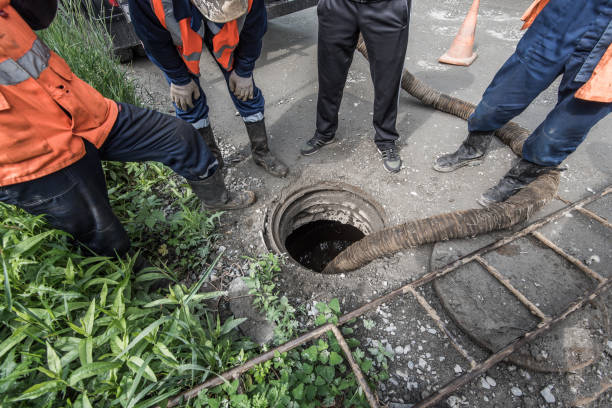 Sewerage accident. Workers pump water. stock photo