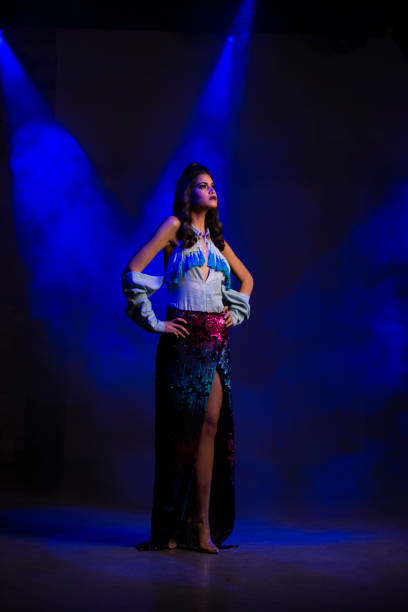 istock Fashion model under disco blue light beam. 990790816
