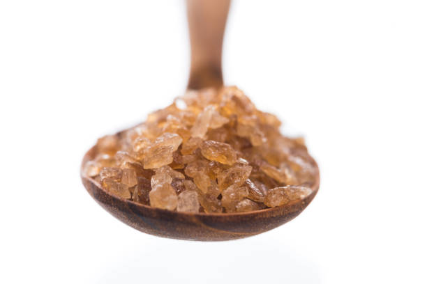 istock Brown rock sugar isolated on white 990791326