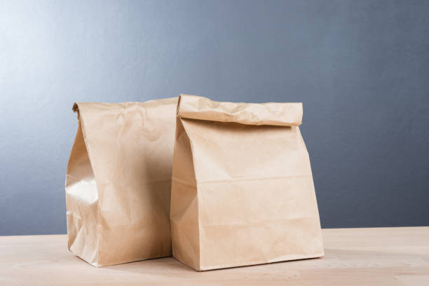 istock simple brown paper bag for lunch or food on table 990797958