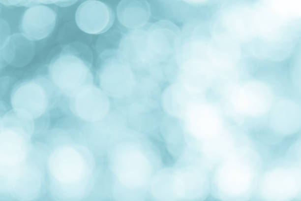 istock Blue and white lights defocused nature blurred or bokeh circles color snow glow colorful light sparkling under a tree with light survived abstract background. 990798696