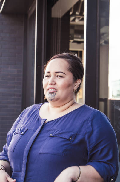 istock Real people - plus size maori female talking outside an office building exterior 990806204