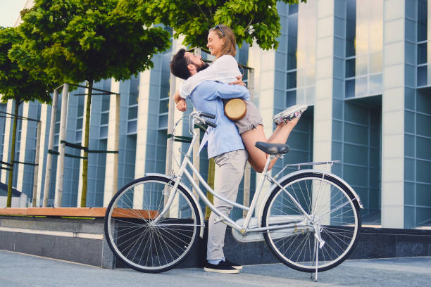 istock A man hugs a woman over modern building background. 990806254