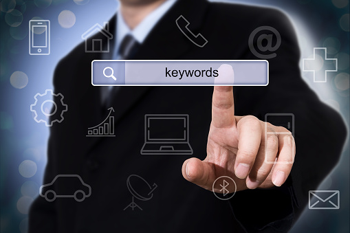 Businessman clicking search field with keywords. Business concept.