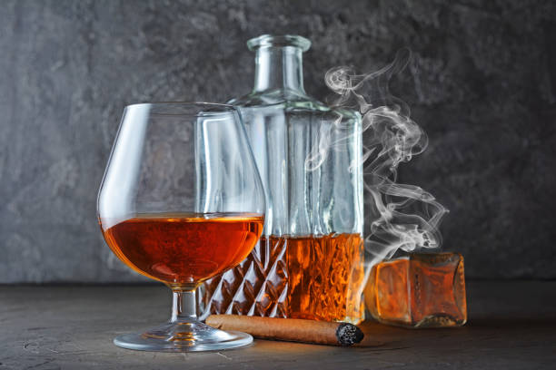 istock Strong alcoholic drink cognac in sniffer glass and crystal decanter 990821644