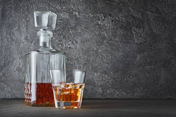 strong alcoholic drink scotch whisky with ice cube in old fashion glass and crystal decanter - decanter crystal carafe glass imagens e fotografias de stock