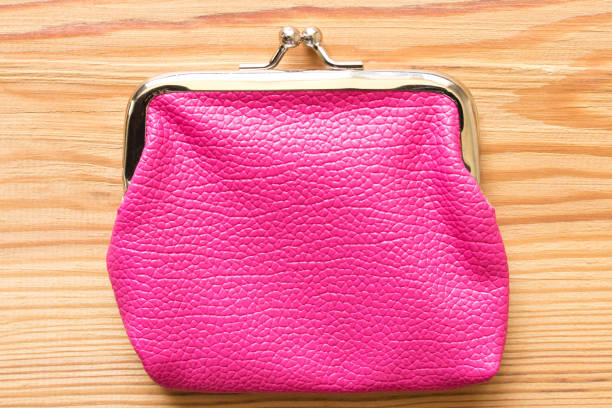 istock Pink purse on a wooden table . Close up. Top view 990833624