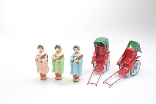 istock Mini statue and red vintage oriental rickshaw cab 990841590