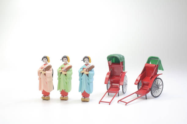 istock Mini statue and red vintage oriental rickshaw cab 990843938