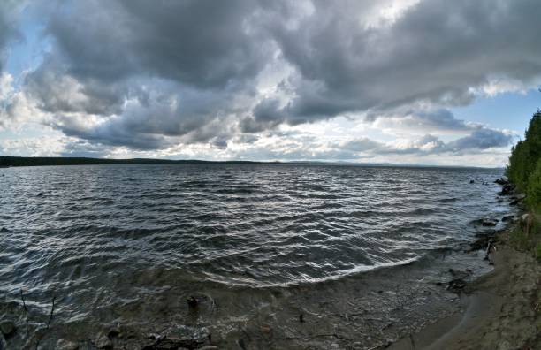 istock dark gray sky over the restless lake 990844080