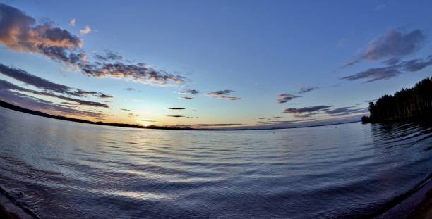 istock dark blue and orange evening sky over the lake 990853650
