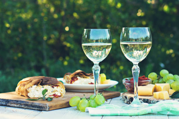 istock White wine and light snacks, Grapes, wine, cheese, pie. 990860502