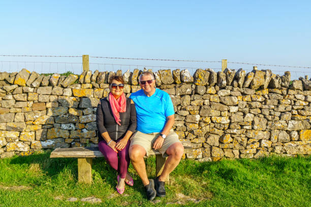 istock Senior couple sitting on bench 990864610