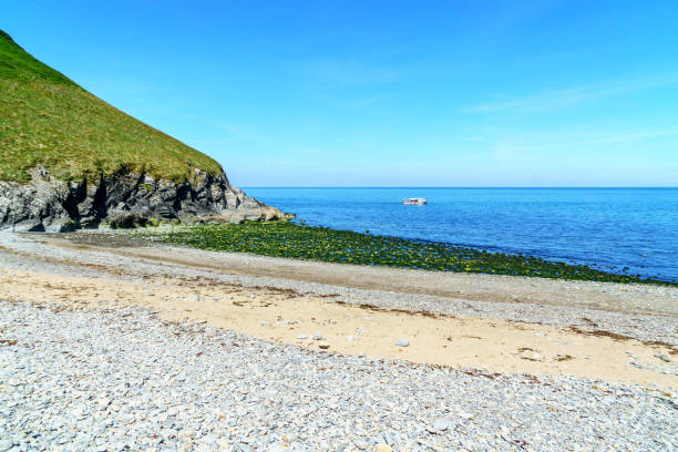 istock Pleasure boat passing Welsh beach 990864688