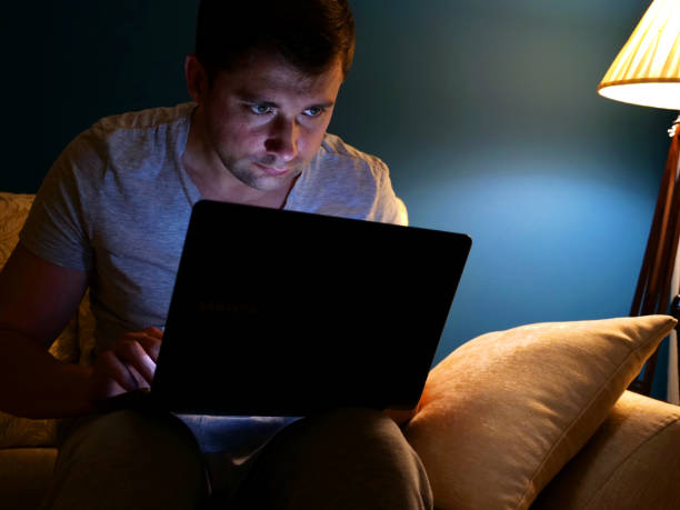 istock Man working with laptop at his house at night. 990864834