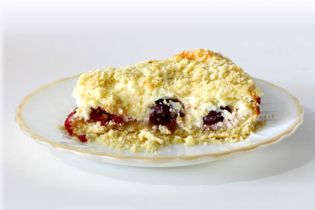 curd cake with crumb and cherries on a plate on a light background