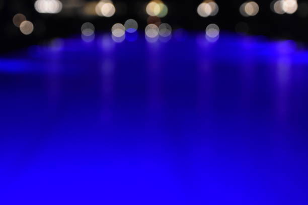 Reflections of lights on a pool at night